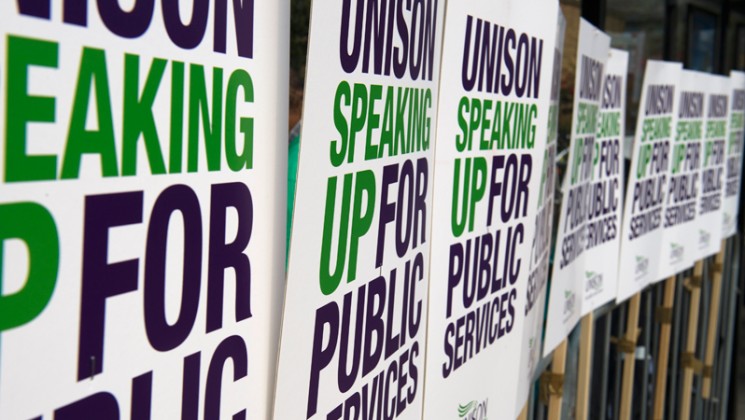 UNISON speaking up for public services placards tied to railing