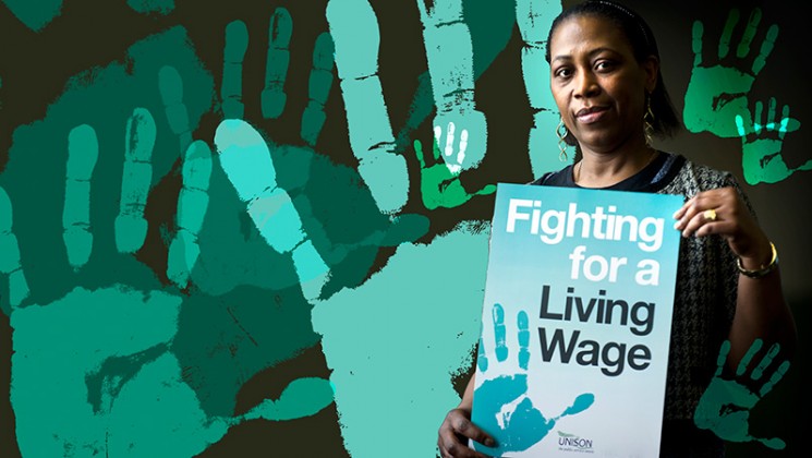 woman holding living wage sign