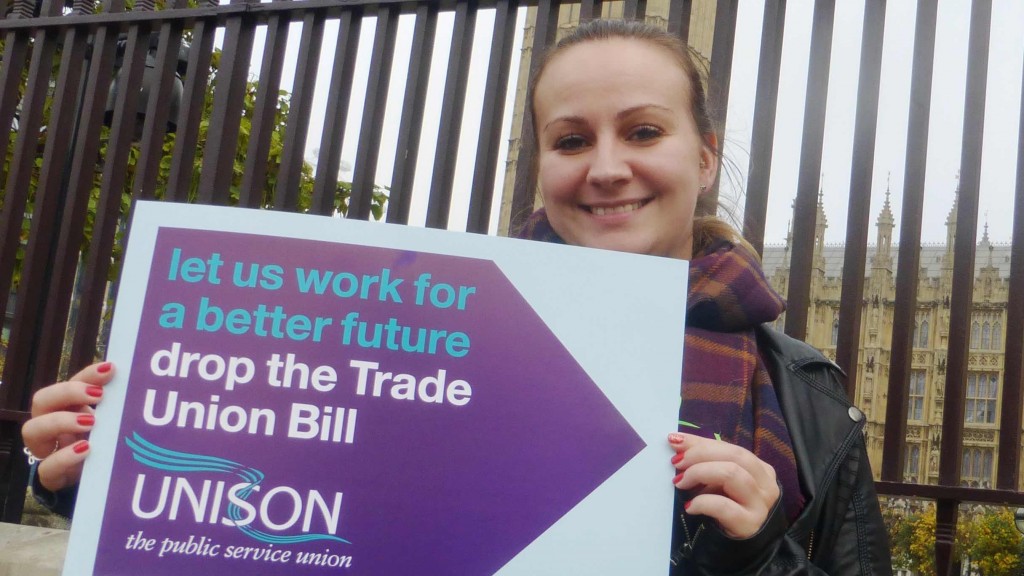 Young woman holds up banner against the Trade Union Bill