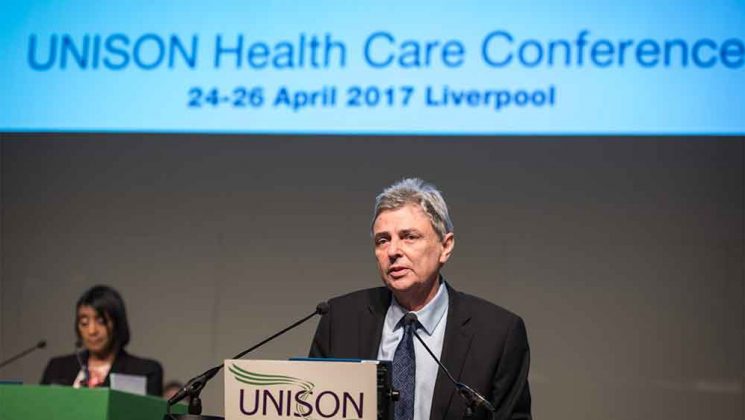 Dave Prenits at the rostrum speaking to UNISON health delegates in Liverpool