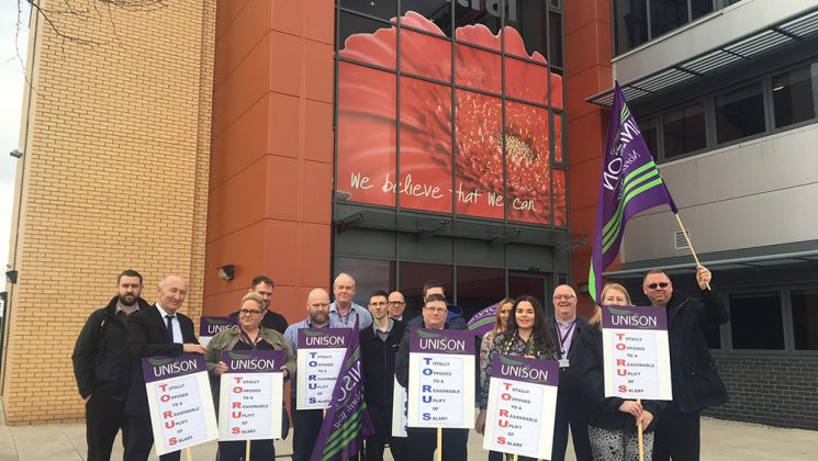 Torus housing workers protesting with placards outside one of its offices