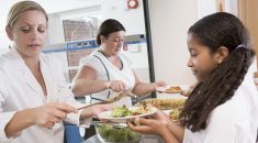 Staff serving school meals to pupils