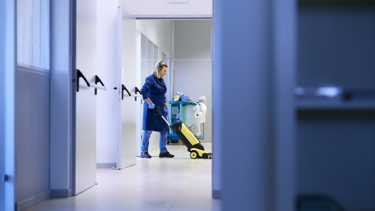 Female cleaner working in a corridor