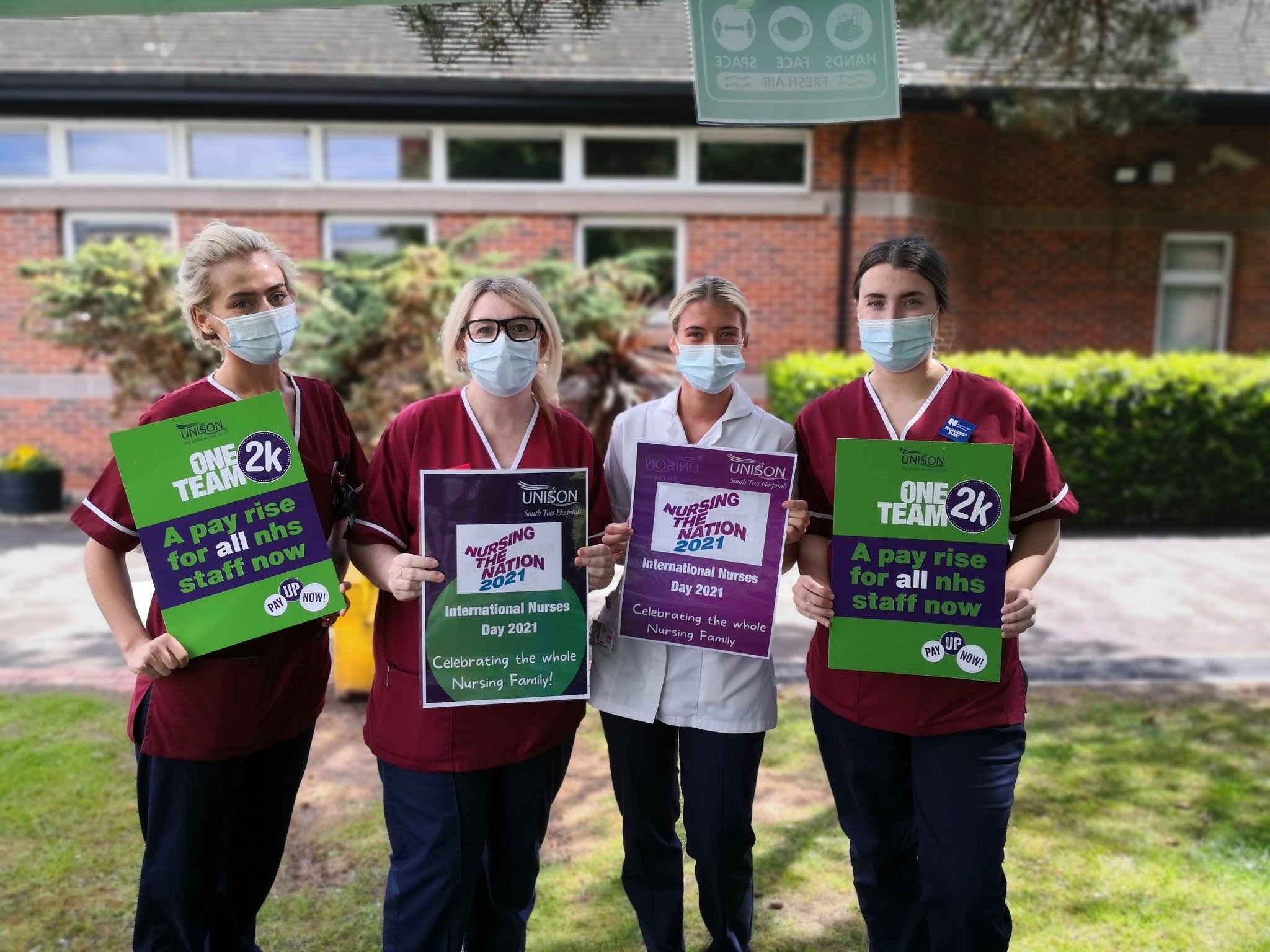 Nurses outside South Tees hospital holding placards