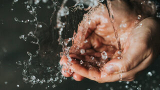 Hands under flowing water
