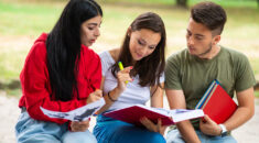 Three students studying outside