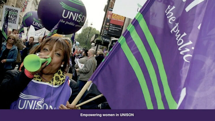 Black woman on a march with UNISON branding