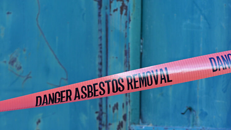 Tape against a blue background reading 'danger asbestos removal'