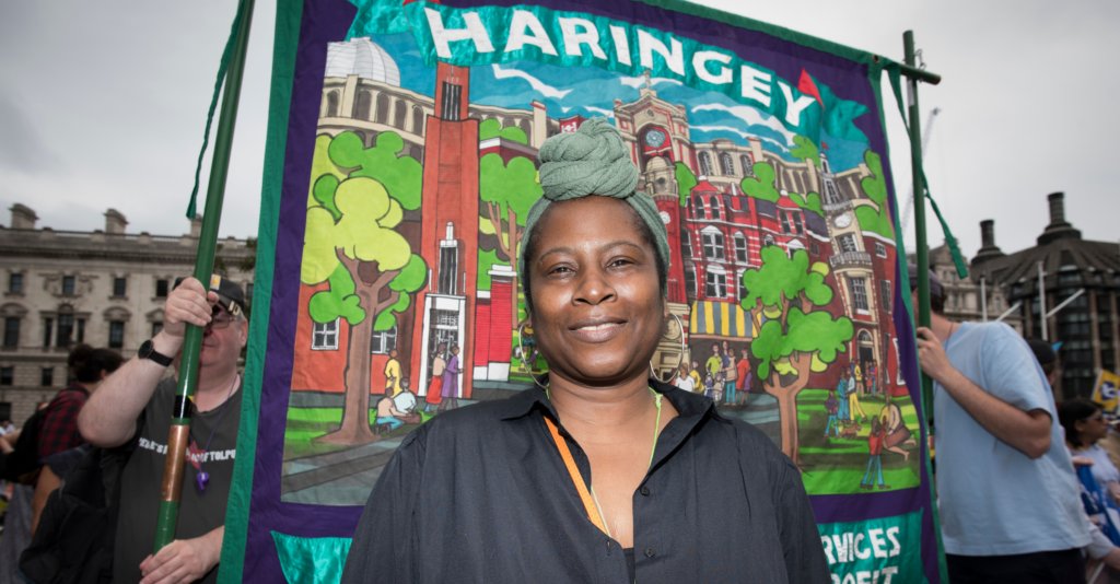 UNISON member faye standing in front of UNISON haringey branch banner at the tuc demo