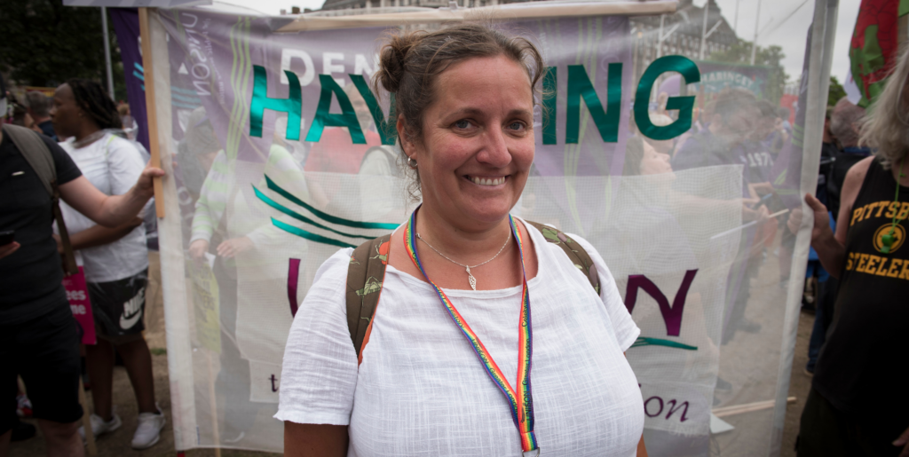 Gabby, UNISON member standing in front of Havering branch banner