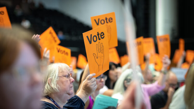 Women hold up positive vote cards