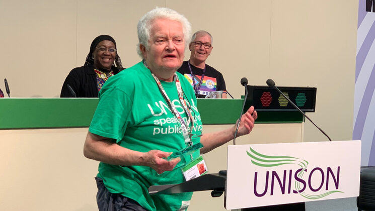 Jackie Lewis at the rostrum, accepting her lifetime achievement award at UNISON's LGBT+ 2022 conference
