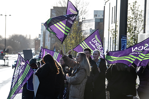 Striking health workers outside The Royal Liverpool University Hospital, Liverpool, UK.