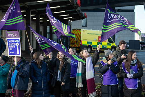 Striking health workers outside The Royal Liverpool University Hospital, Liverpool, UK.