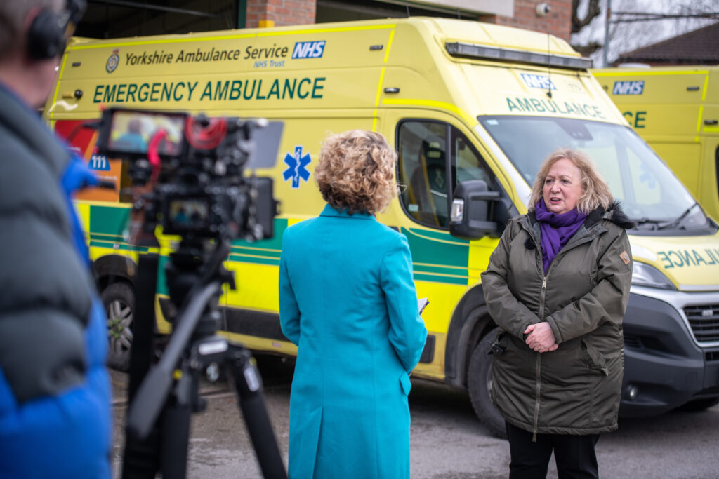 Cathy Newman interviews Christina McAnea on camera in front of an ambulance at York ambulance station
