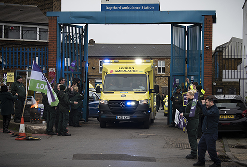 Pickets at Deptford applaud as emergency cover ambulance leave the station