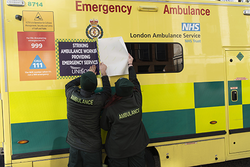Pickets at Waterloo attaching a sign to an ambulance to stress provision of emergency cover