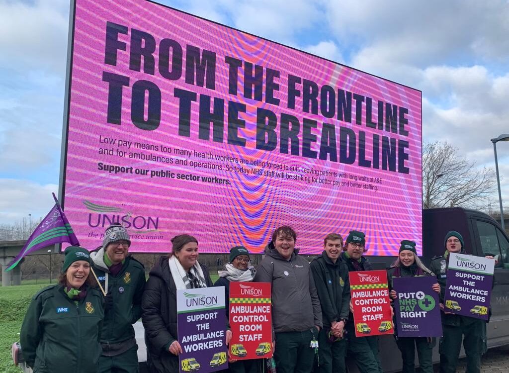 UNISON ambulance workers at Deptford in front of a giant pink ad-van which reads 'From the Frontline to the Breadline