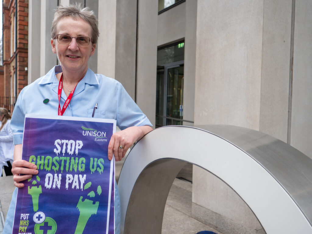 Joyce Aldridge, head of UNISON Eastern's health committee,holds a placard saying: "stop ghosting us on pay"