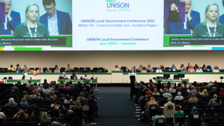 Local government conference 2023 set, platform and rostrum, seen from back of hall, behind delegates