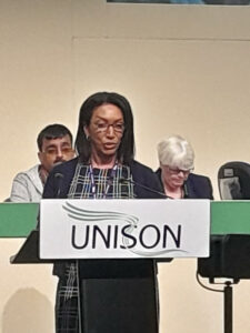 Photo of Denise Thomas speaking at the UNISON podium