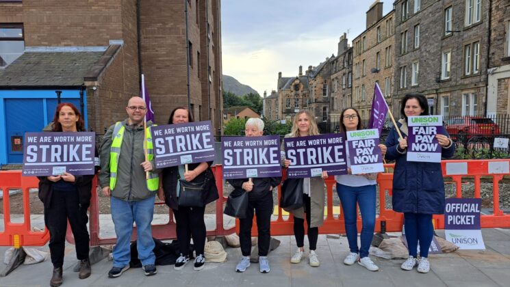 Picketers holding up signs at the 2023 Scottish school strikes