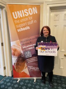 Paula Barker MP holding a 'Stars in Our Schools' sign