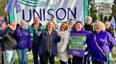 Christina McAnea stands in front of UNISON banner with UNISON Scotland members