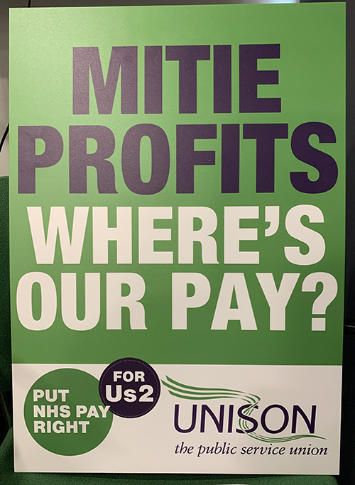 A placard for Mitie workers saying 'where's our pay' in contrast to the company's profits
