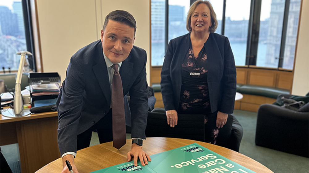 Wes Streeting signing UNISON's National Care Campaign pledge alongside Christina McAnea at Westminster