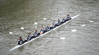 Female crew of eight in a rowing boat on the Thames