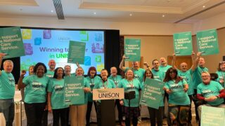 Community members stage a photo op in support of a national care service at UNISON's national community seminar and conference 2024