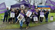 Hospital workers in Wiltshire hold purple UNISON flags on the picket line