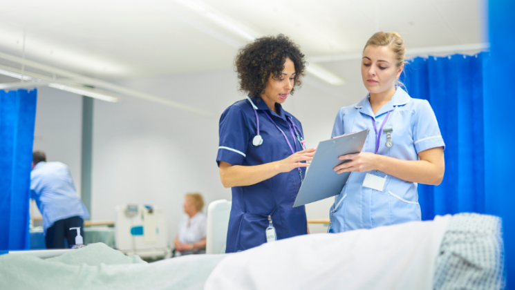 two female bank nurses reading notes