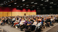 Photo of the hall full of seated delegates